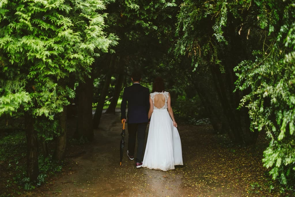 Newlyweds walking through a forest