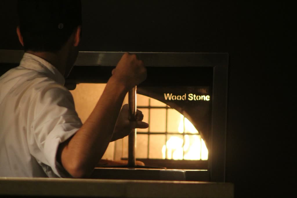 Chef at the wood-fired oven